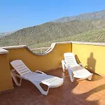 With A Serene Ocean And Mountain View *