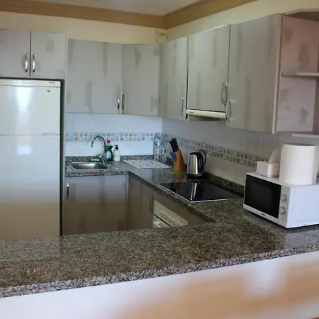 With A Serene Ocean And Mountain View Адехе