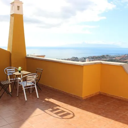 With A Serene Ocean And Mountain View *