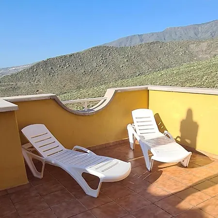 With A Serene Ocean And Mountain View *